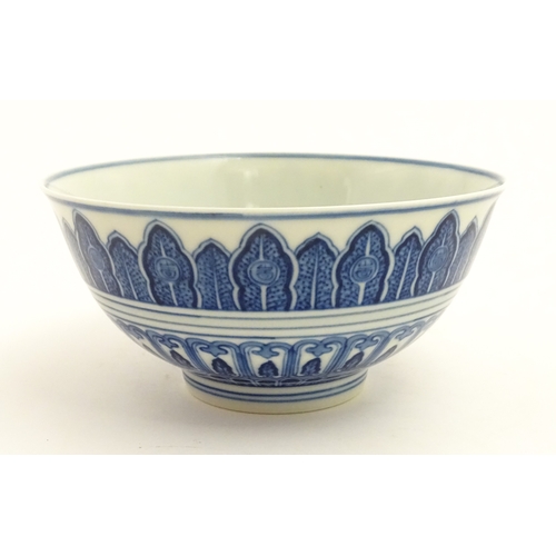70 - A Chinese blue and white bowl decorated with banded foliate detail, and central flower motif. Charac... 