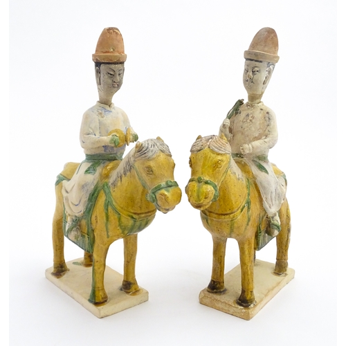 73 - A pair of Chinese Sancai glazed pottery models of a horse and rider / riders on horseback. Approx. 1... 