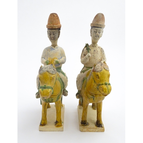 73 - A pair of Chinese Sancai glazed pottery models of a horse and rider / riders on horseback. Approx. 1... 