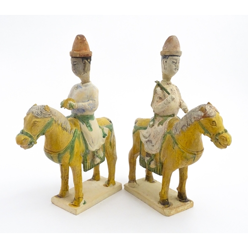 73 - A pair of Chinese Sancai glazed pottery models of a horse and rider / riders on horseback. Approx. 1... 
