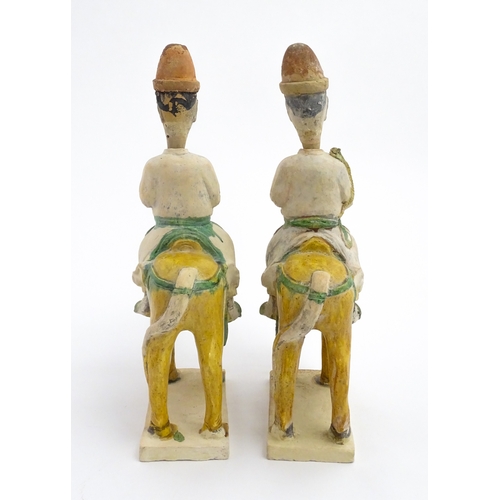 73 - A pair of Chinese Sancai glazed pottery models of a horse and rider / riders on horseback. Approx. 1... 