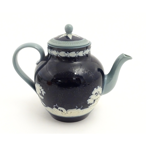 86 - A Copeland Spode jasperware teapot decorated with a hunting scene with horses and hounds. Marked und... 