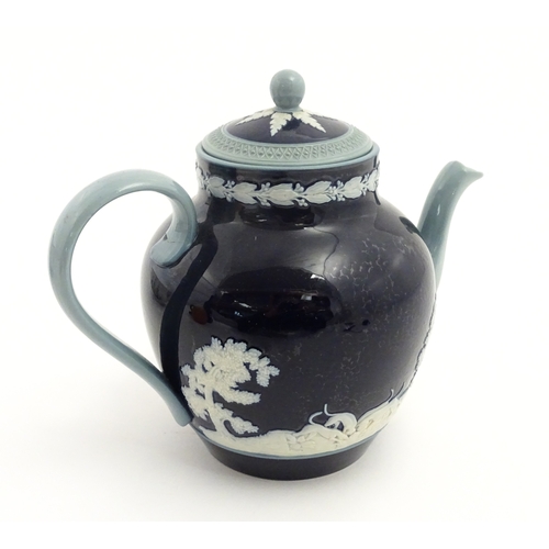 86 - A Copeland Spode jasperware teapot decorated with a hunting scene with horses and hounds. Marked und... 