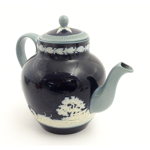 86 - A Copeland Spode jasperware teapot decorated with a hunting scene with horses and hounds. Marked und... 