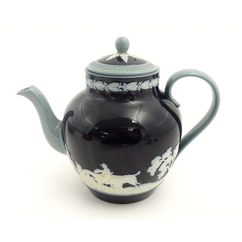 86 - A Copeland Spode jasperware teapot decorated with a hunting scene with horses and hounds. Marked und... 