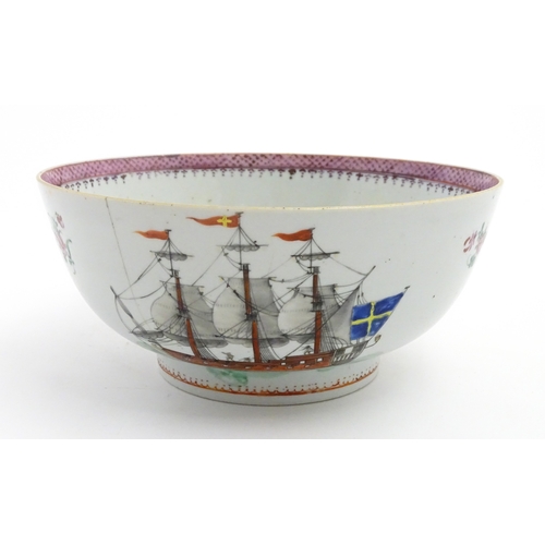 61 - A Chinese export famille rose 'ship' punch bowl decorated with hand painted ships flying the Swedish... 