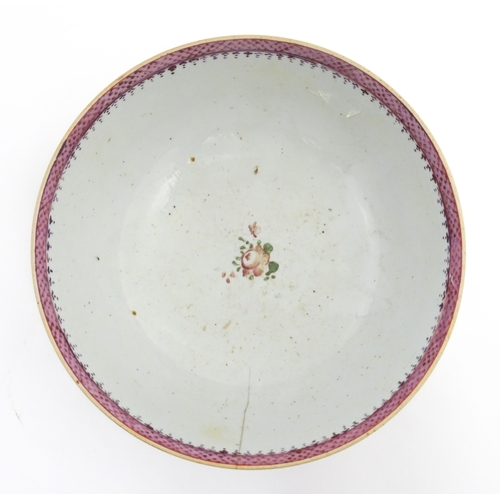 61 - A Chinese export famille rose 'ship' punch bowl decorated with hand painted ships flying the Swedish... 