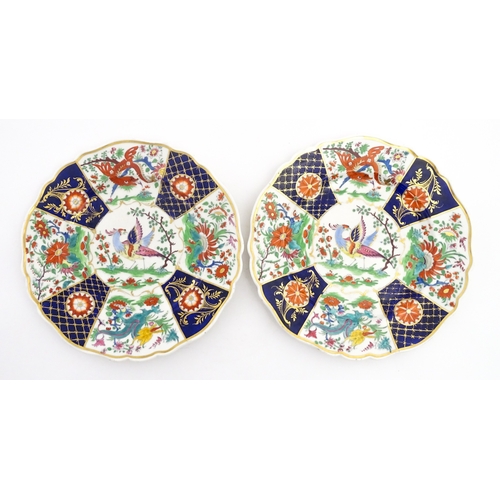 90 - A pair of English plates decorated in the Imari palette depicting a bird to centre bordered by flowe... 