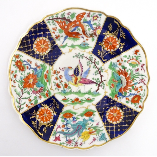 90 - A pair of English plates decorated in the Imari palette depicting a bird to centre bordered by flowe... 