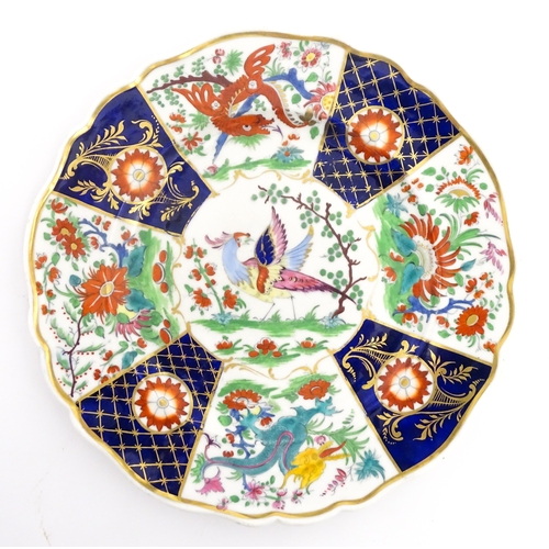 90 - A pair of English plates decorated in the Imari palette depicting a bird to centre bordered by flowe... 