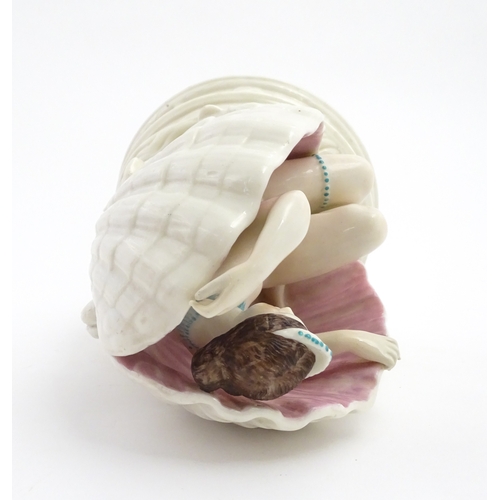 91 - An English figure modelled as the Birth of Venus / Venus emerging from a sea shell, with pink and bl... 