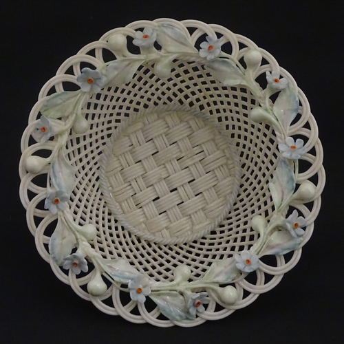 93 - A Belleek four strand basket with painted Forget-Me-Not flowers and leaves to rim. Bears First Perio... 