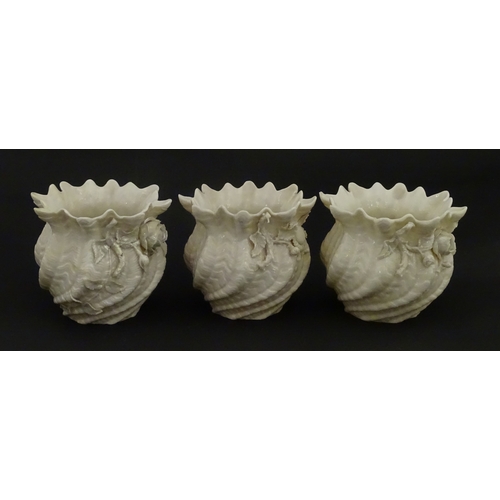 94 - Three small Belleek Neptune vases / jardinieres with applied flower and foliage decoration. Each bea... 