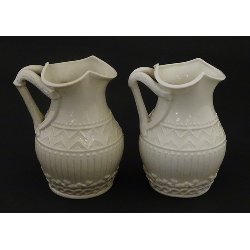 96 - A pair of Belleek Harp jugs / pitchers with banded decoration. Both bearing Second Period marks unde... 