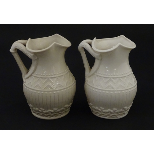 96 - A pair of Belleek Harp jugs / pitchers with banded decoration. Both bearing Second Period marks unde... 