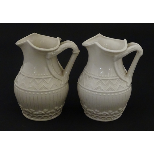 96 - A pair of Belleek Harp jugs / pitchers with banded decoration. Both bearing Second Period marks unde... 
