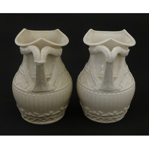 96 - A pair of Belleek Harp jugs / pitchers with banded decoration. Both bearing Second Period marks unde... 