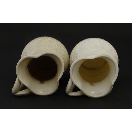 96 - A pair of Belleek Harp jugs / pitchers with banded decoration. Both bearing Second Period marks unde... 