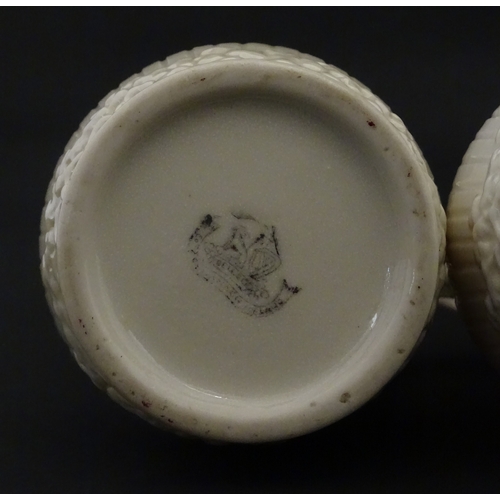 96 - A pair of Belleek Harp jugs / pitchers with banded decoration. Both bearing Second Period marks unde... 