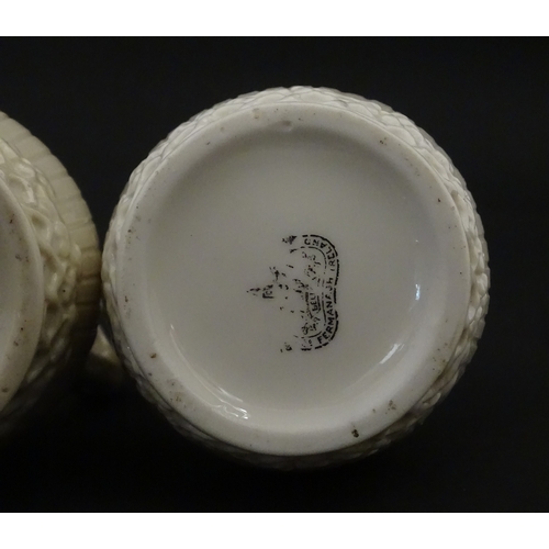 96 - A pair of Belleek Harp jugs / pitchers with banded decoration. Both bearing Second Period marks unde... 