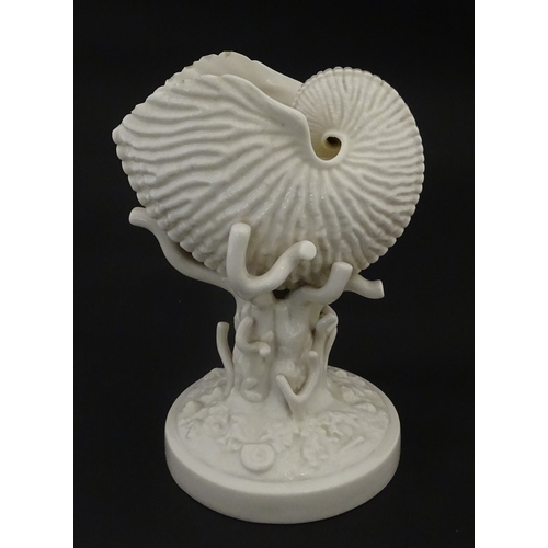 98 - A Belleek Nautilus Shell comport / centrepiece vase with stylised coral base. Bearing First Period m... 