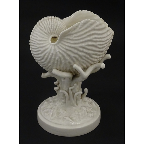 98 - A Belleek Nautilus Shell comport / centrepiece vase with stylised coral base. Bearing First Period m... 