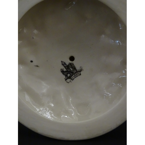 98 - A Belleek Nautilus Shell comport / centrepiece vase with stylised coral base. Bearing First Period m... 