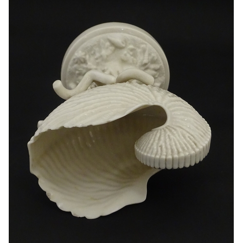 98 - A Belleek Nautilus Shell comport / centrepiece vase with stylised coral base. Bearing First Period m... 