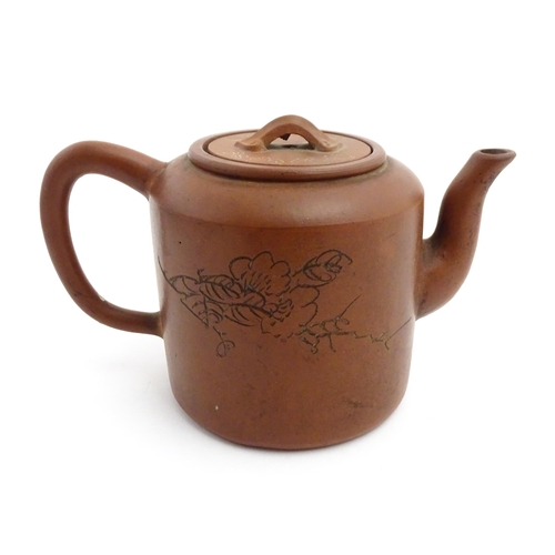 55A - A Chinese yixing teapot with incised Character mark and flower decoration. Character marks under. Ap... 