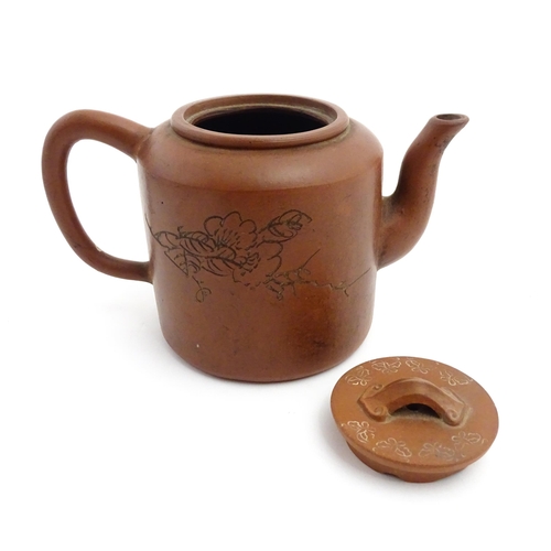 55A - A Chinese yixing teapot with incised Character mark and flower decoration. Character marks under. Ap... 