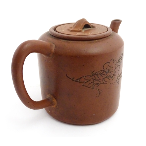 55A - A Chinese yixing teapot with incised Character mark and flower decoration. Character marks under. Ap... 