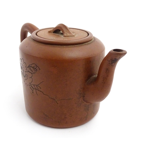 55A - A Chinese yixing teapot with incised Character mark and flower decoration. Character marks under. Ap... 