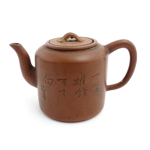 55A - A Chinese yixing teapot with incised Character mark and flower decoration. Character marks under. Ap... 