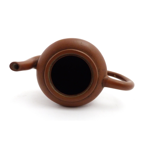 55A - A Chinese yixing teapot with incised Character mark and flower decoration. Character marks under. Ap... 