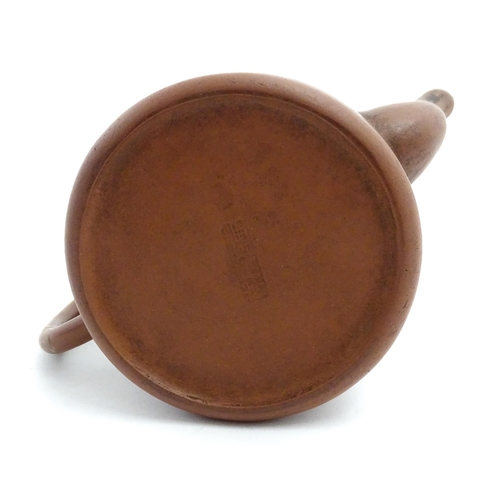 55A - A Chinese yixing teapot with incised Character mark and flower decoration. Character marks under. Ap... 