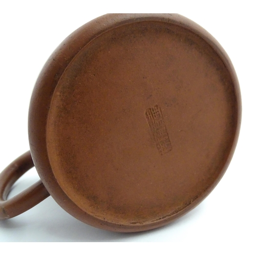55A - A Chinese yixing teapot with incised Character mark and flower decoration. Character marks under. Ap... 