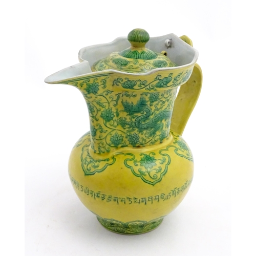 75 - A Chinese yellow ground wine ewer decorated with green dragons and lotus flowers. Character marks un... 