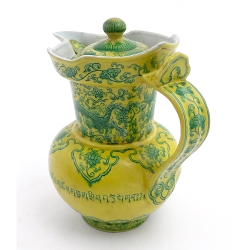 75 - A Chinese yellow ground wine ewer decorated with green dragons and lotus flowers. Character marks un... 