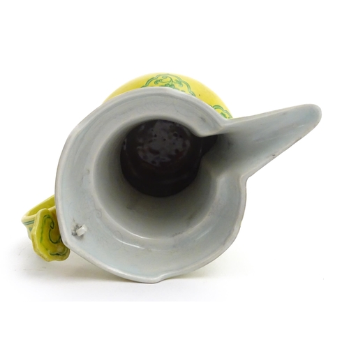 75 - A Chinese yellow ground wine ewer decorated with green dragons and lotus flowers. Character marks un... 