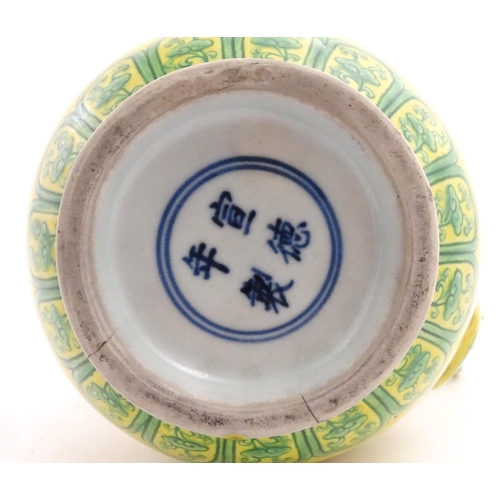 75 - A Chinese yellow ground wine ewer decorated with green dragons and lotus flowers. Character marks un... 