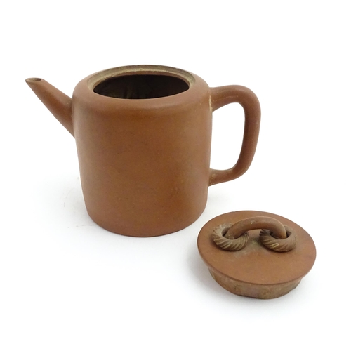 77 - A Chinese yixing teapot with rope detail to lid. Character marks under. Approx. 4 1/2