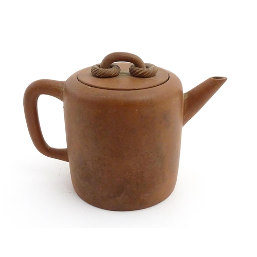 77 - A Chinese yixing teapot with rope detail to lid. Character marks under. Approx. 4 1/2