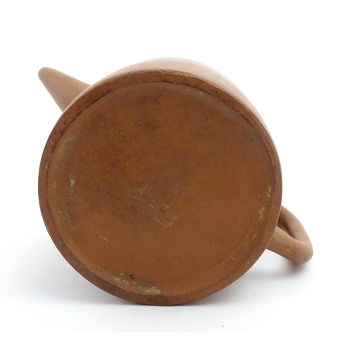 77 - A Chinese yixing teapot with rope detail to lid. Character marks under. Approx. 4 1/2