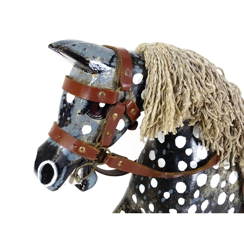 6 - Toy: A 20thC carved wooden rocking horse with hand painted decoration by Norman Dibben of Amersham, ... 
