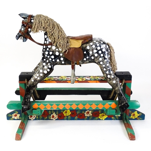 6 - Toy: A 20thC carved wooden rocking horse with hand painted decoration by Norman Dibben of Amersham, ... 