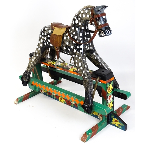 6 - Toy: A 20thC carved wooden rocking horse with hand painted decoration by Norman Dibben of Amersham, ... 