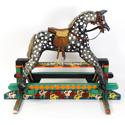 6 - Toy: A 20thC carved wooden rocking horse with hand painted decoration by Norman Dibben of Amersham, ... 