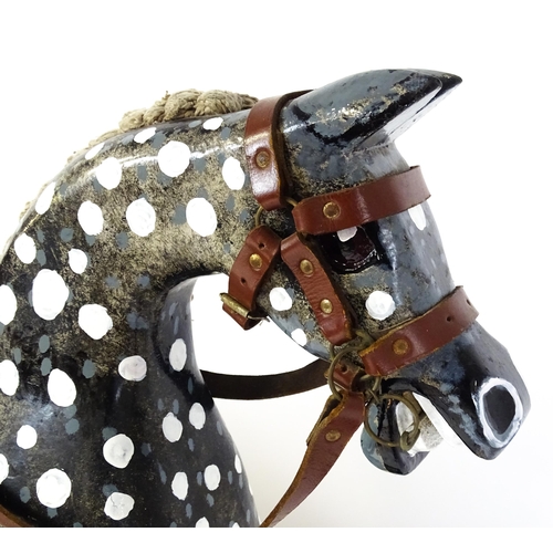 6 - Toy: A 20thC carved wooden rocking horse with hand painted decoration by Norman Dibben of Amersham, ... 