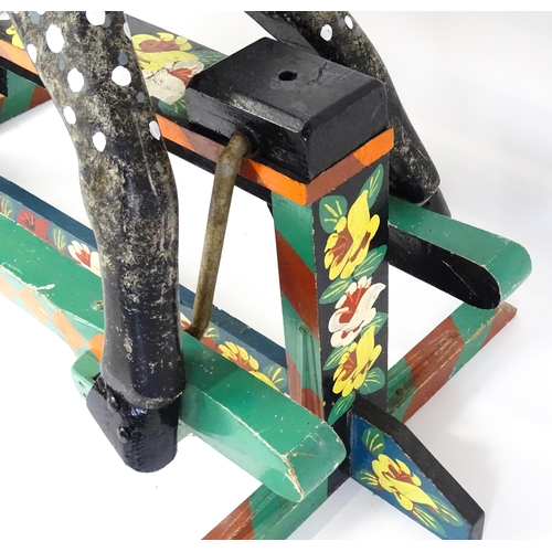 6 - Toy: A 20thC carved wooden rocking horse with hand painted decoration by Norman Dibben of Amersham, ... 