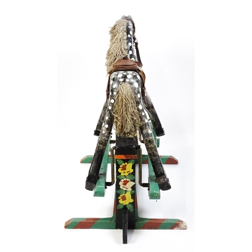 6 - Toy: A 20thC carved wooden rocking horse with hand painted decoration by Norman Dibben of Amersham, ... 